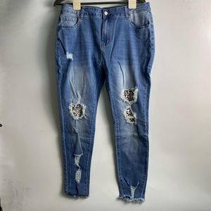 distressed denim jeans with leopard print patches